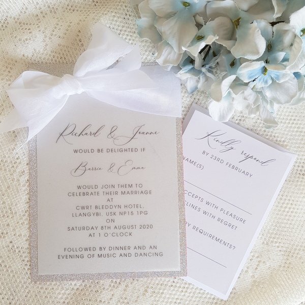 vellum and glitter invitation with white silk ribbon