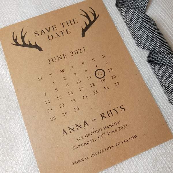 wedding save the date card with a calendar and a stag antlers design, printed on brown rustic recycled card