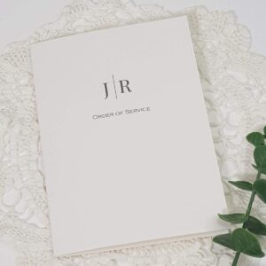 white wedding order of service with a contemporary monogram design