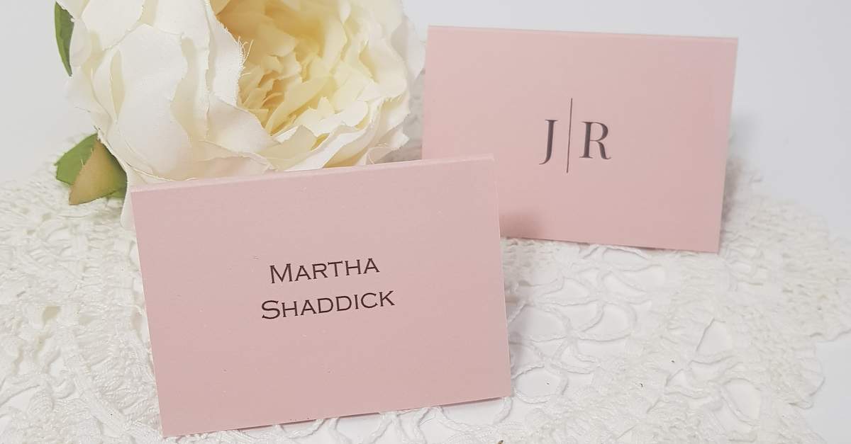 blush pink personalised wedding place cards with a modern font and monogram