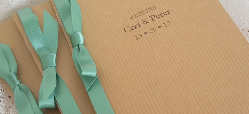 rustic kraft wedding order of service with a sage green satin ribbon for decoration