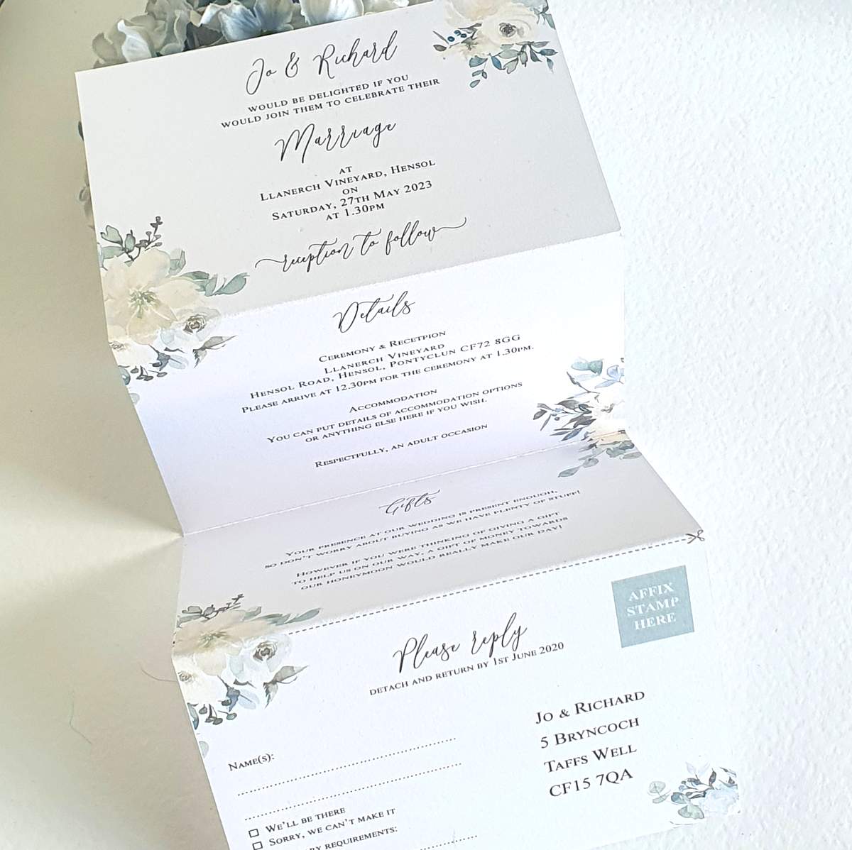 concertina style wedding invitation with a white and green floral design printed on eco friendly recycled card