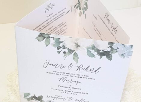 A green and white pocketfold invitation made from recycled card