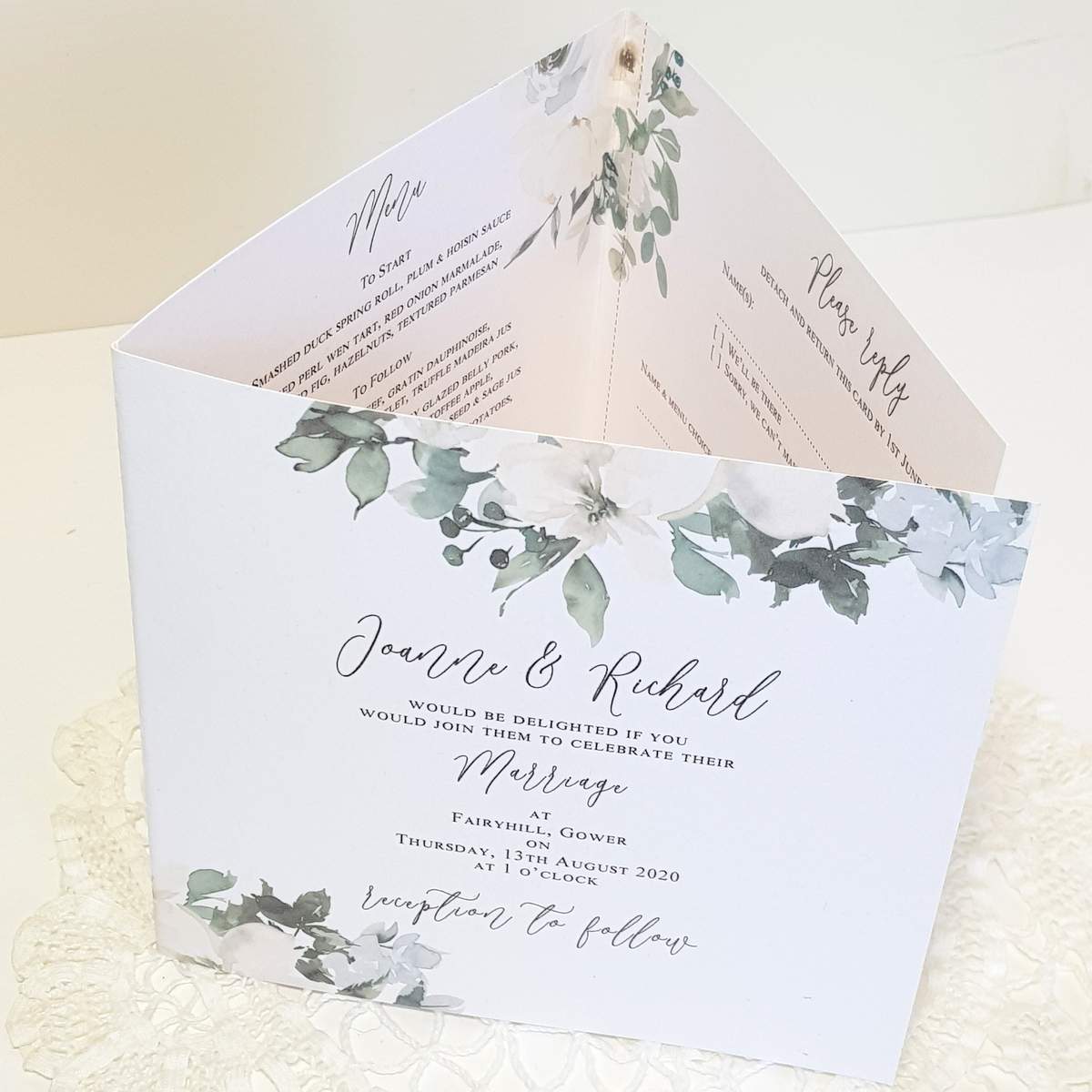 A green and white pocketfold invitation made from recycled card