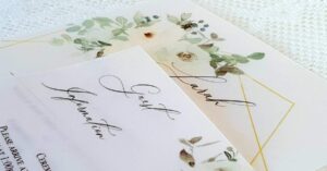 pretty wedding invitations with pale green and white flowers printed on vellum