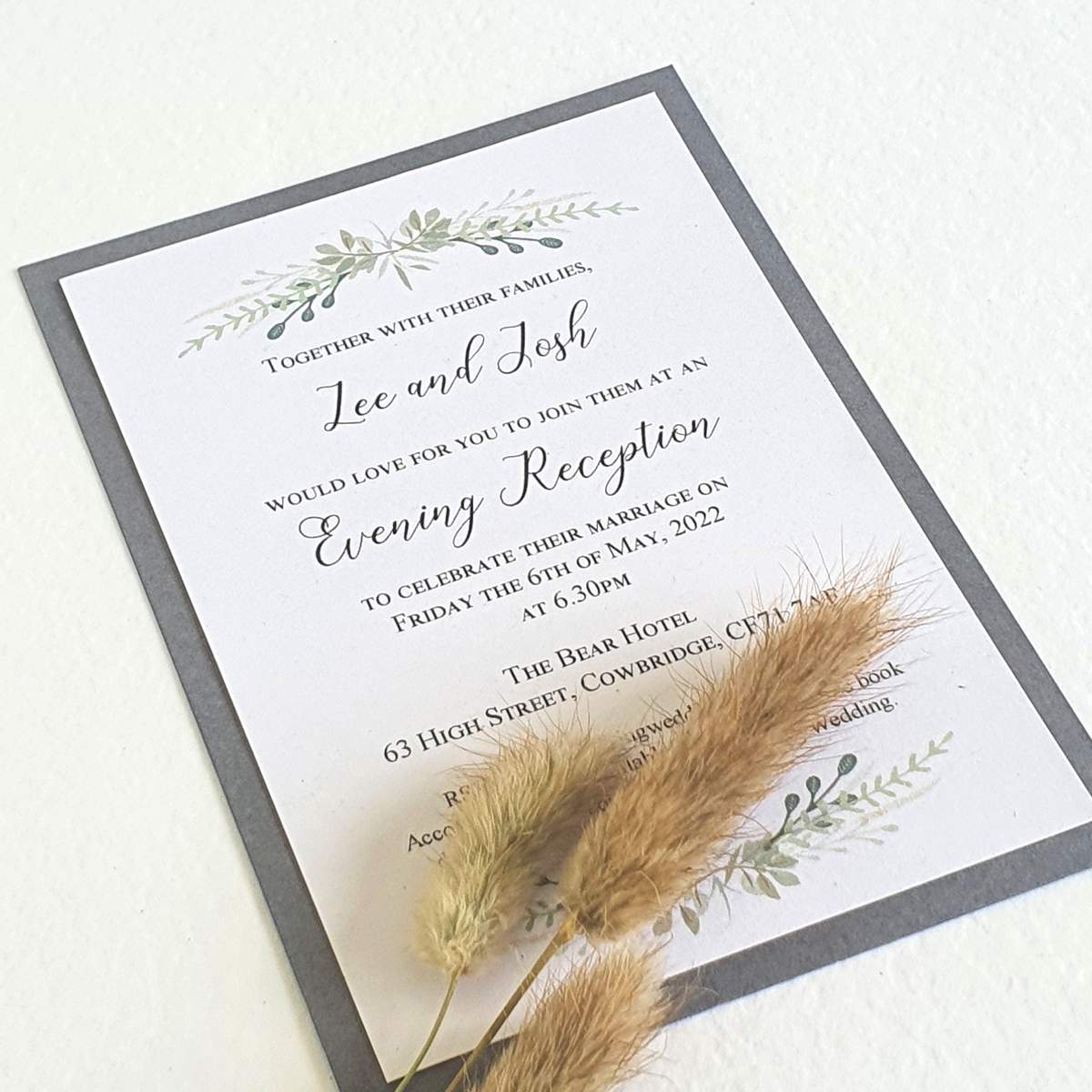 evening wedding invitation with a modern greenery swag design and a grey border