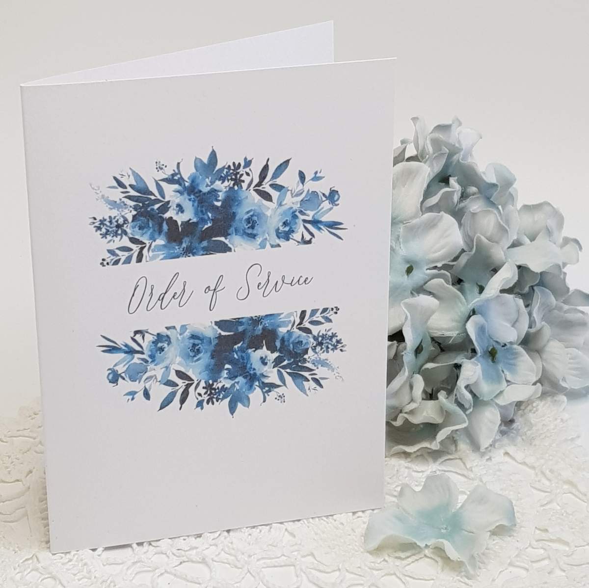wedding ceremony order of service booklet with a navy blur floral print