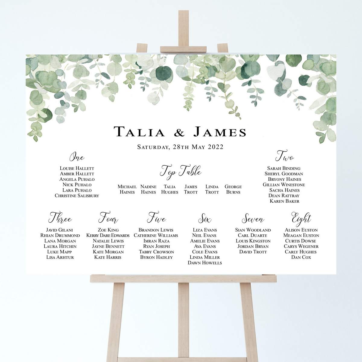 a wedding table plan with greenery foliage design at the top