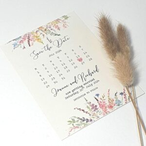 wedding save the date card with a calendar style print and watercolour meadow flowers at the top and bottom
