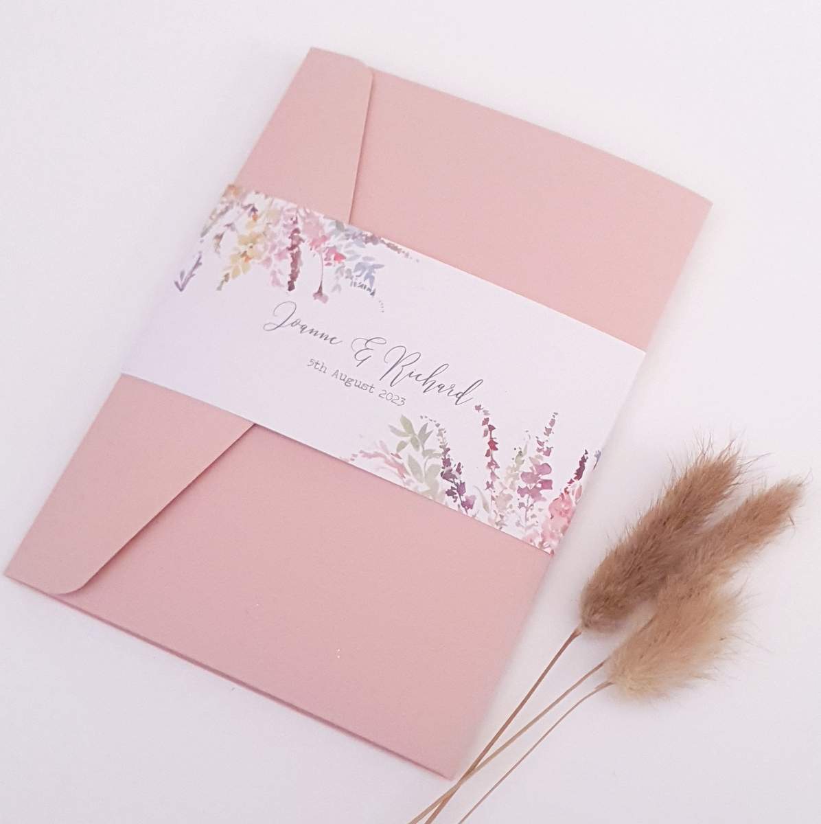 pale pink pocketfold wedding invitation with a pretty meadow flowers watercolour design