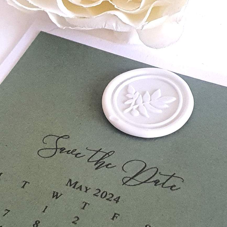 sage green wedding save the date calendar card with a white wax seal