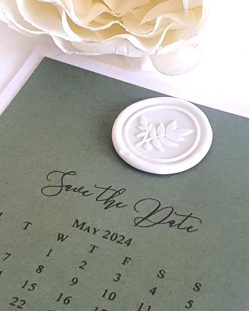 sage green save the date card with white wax seal