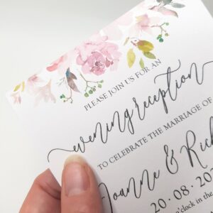 an evening wedding invitation with a lilac floral design at the top