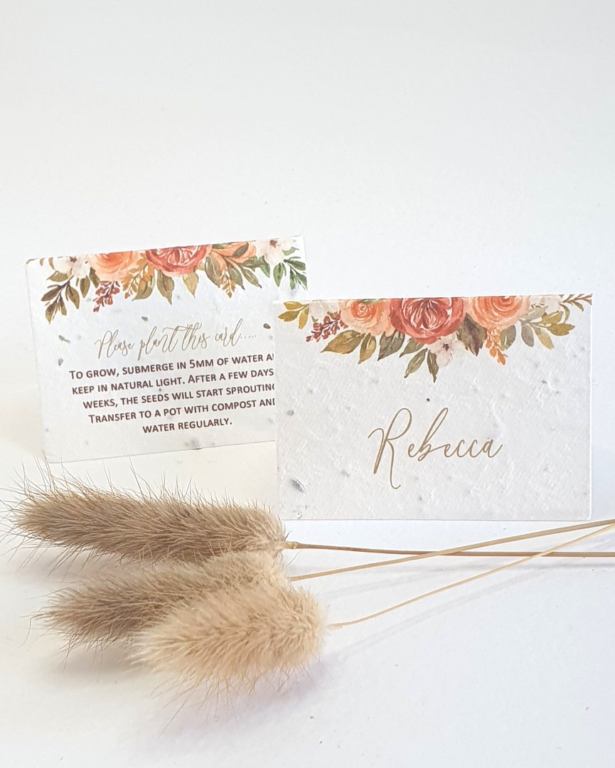 wedding place cards printed onto plantable seed paper. An autumnal floral design on the front with the guest names, planting instructions on the back