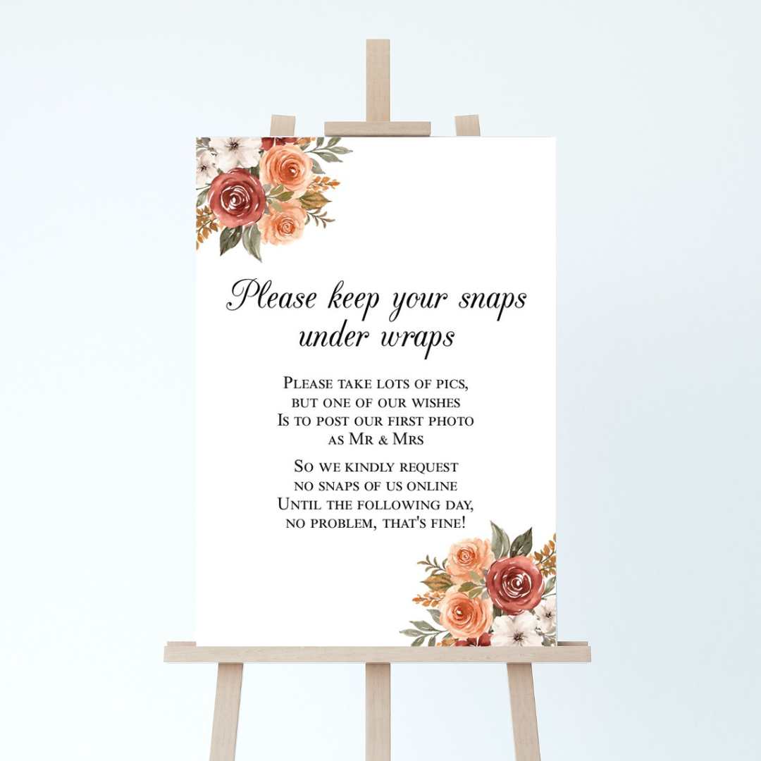a wedding sign with an autumnal design, asking guests to keep their snaps under wraps until after the day
