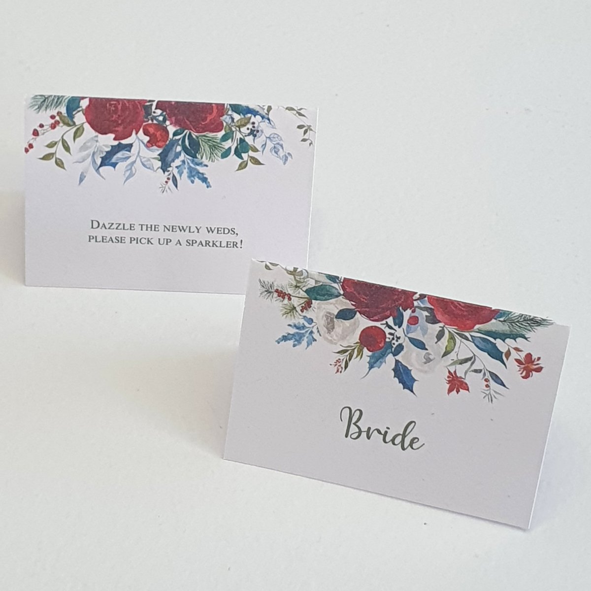 wedding place cards with a festive read and green floral design