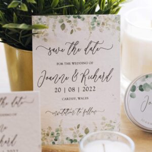 a wedding save the date card with a greenery cascade design