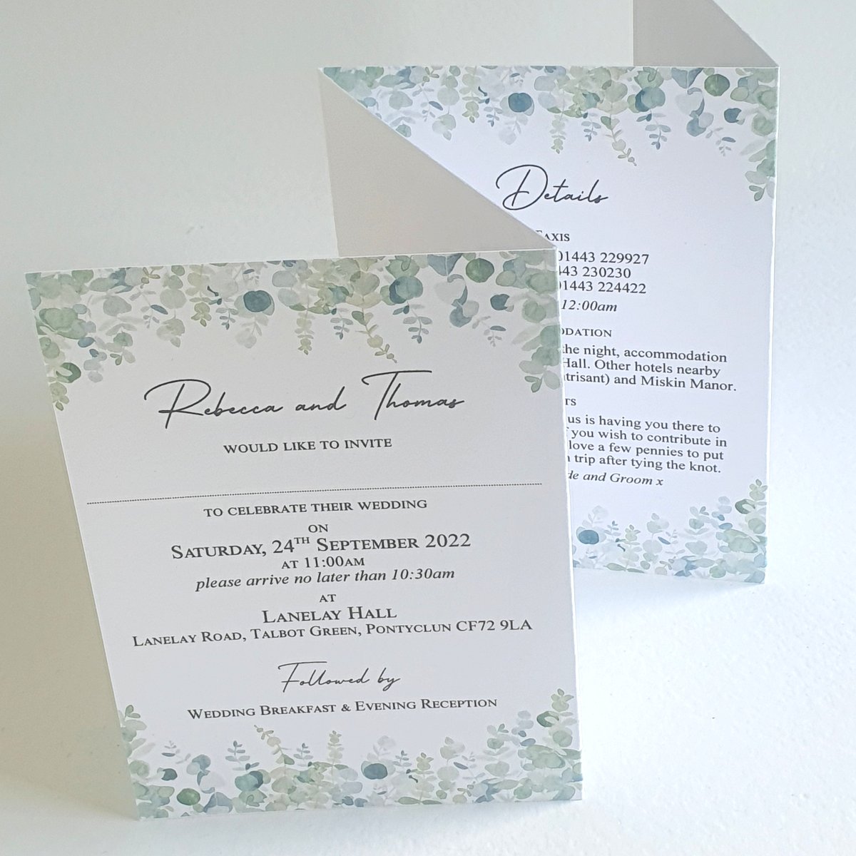 a concertina style wedding invitation with a cascading greenery design top and bottom