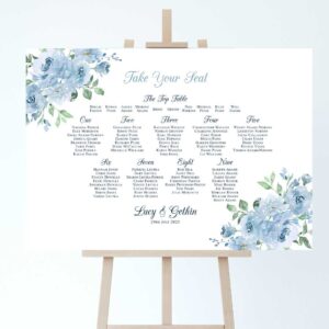 a wedding table plan on an easel with sky blue floral accents to the corners