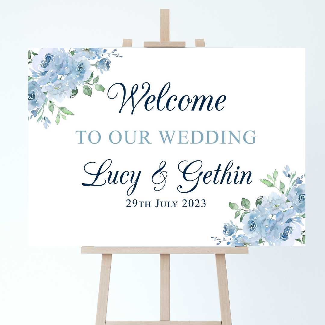 a wedding welcome sign on an easel with sky blue floral accents to the corners