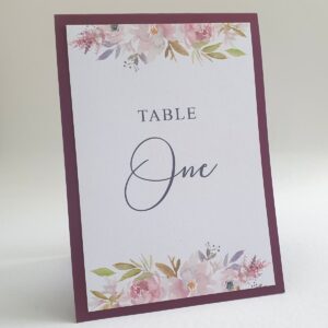 a wedding table number with mauve floral design, the border is burgundy