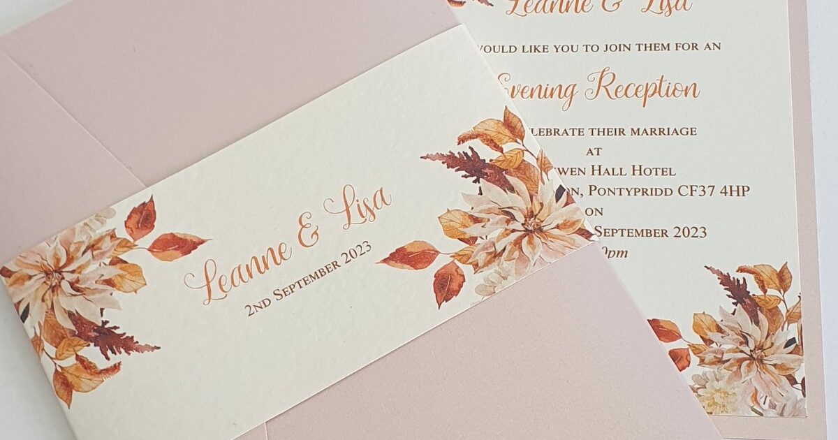 an autumnal theme set of wedding invitations, one has a duty pink folder, secured with a centre band printed with autumnal foliage