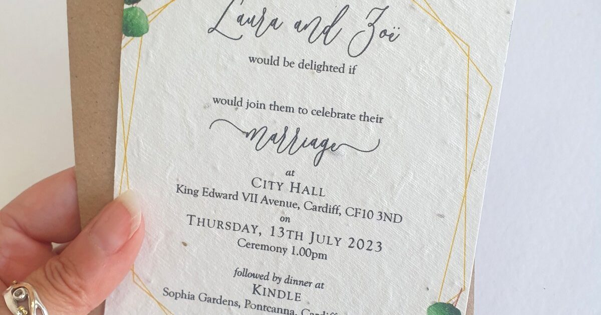 a wedding invitation with green eucalyptus design to the corners. It is printed onto seed paper and is shown with a brown recycled kraft envelope